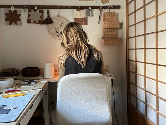 suzanne paradijs at work in her studio with shoji screen fronted closet  